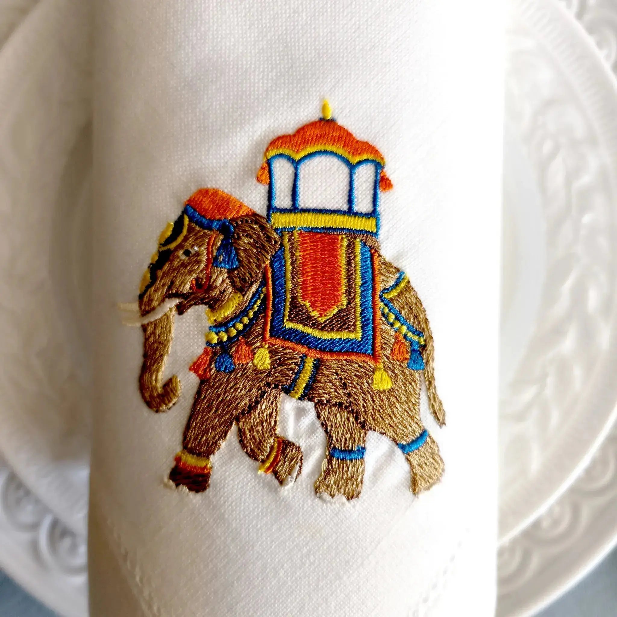Embroidered linen dinner napkin with creative embroidery inspired by Indian decorated elephant