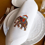 Embroidered linen dinner napkin with creative embroidery inspired by Indian decorated elephant