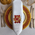 Embroidered linen dinner napkins with elegant monogrammed embroidery for fine dining table
