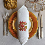 Embroidered linen dinner napkins with elegant monogrammed embroidery for fine dining table