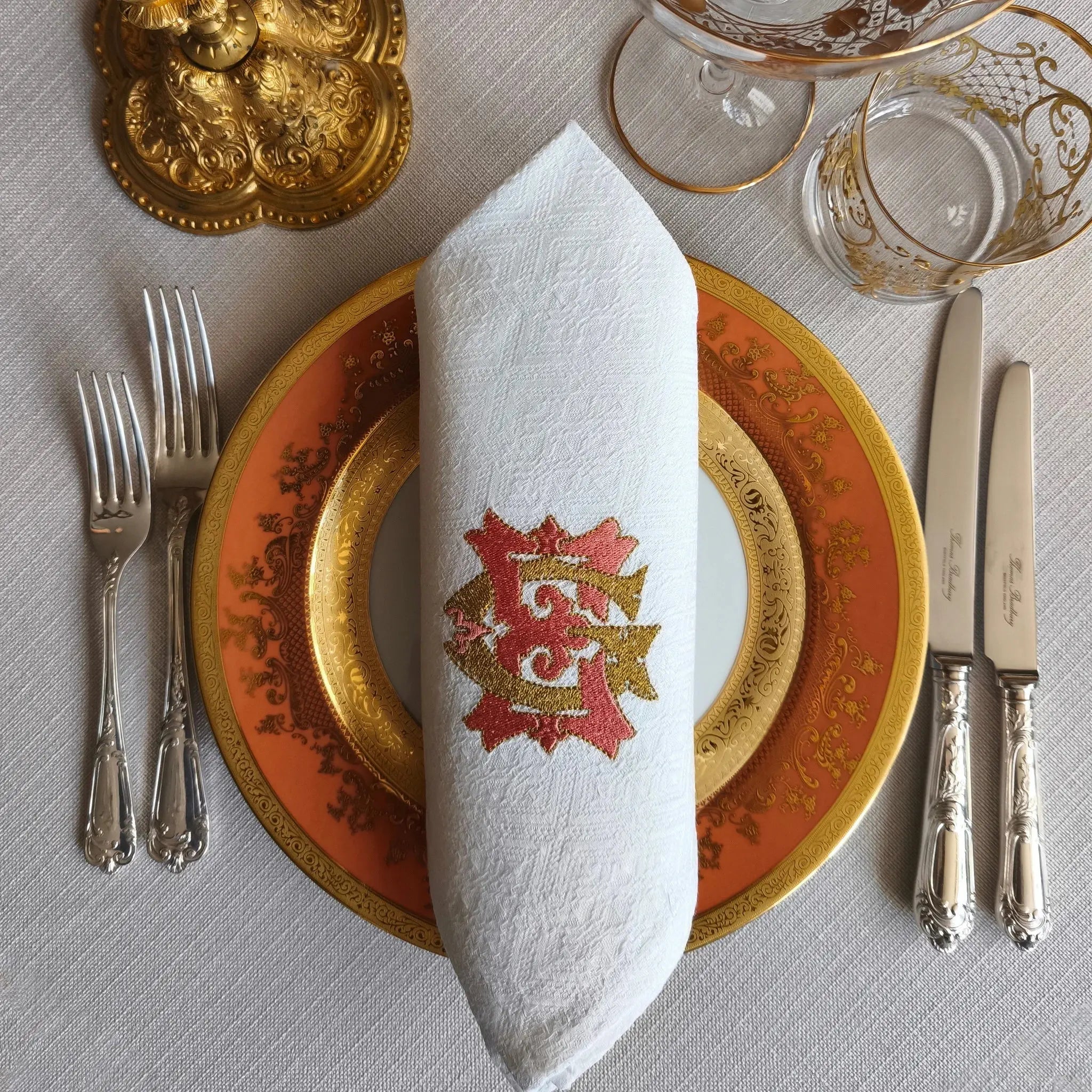 Embroidered linen dinner napkins with elegant monogrammed embroidery for fine dining table
