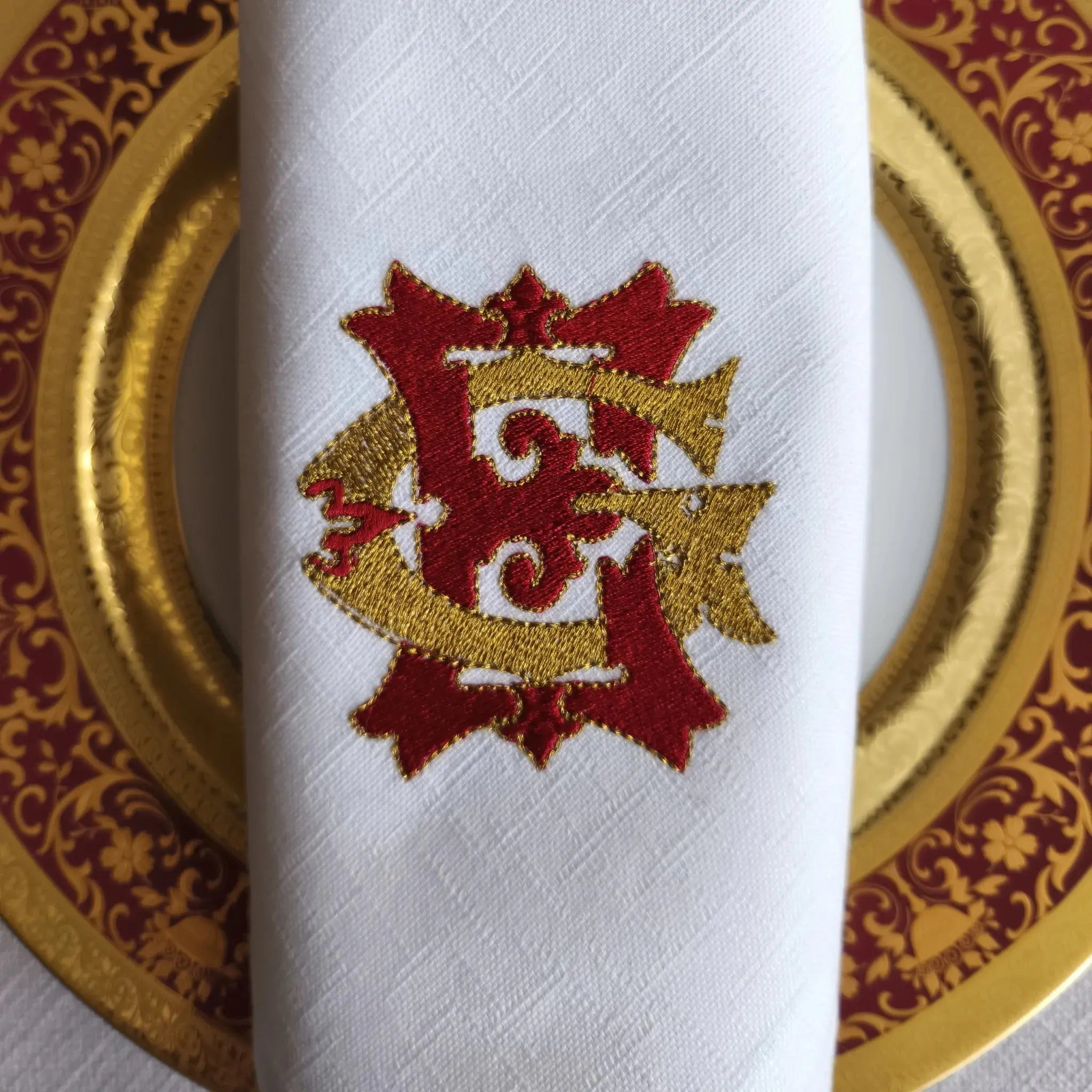 Embroidered linen dinner napkins with elegant monogrammed embroidery for fine dining table