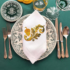 Embroidered linen dinner napkins with elegant golden nut for fine dining table