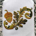 Embroidered linen dinner napkins with elegant golden nut for fine dining table