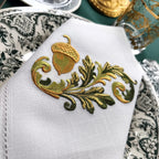 Embroidered linen dinner napkins with elegant golden nut for fine dining table
