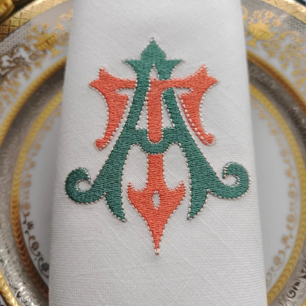 Embroidered linen dinner napkins with elegant monogrammed embroidery for fine dining table