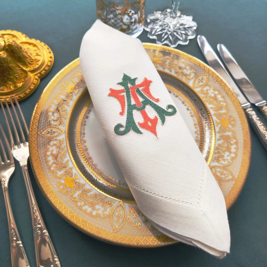 Embroidered linen dinner napkins with elegant monogrammed embroidery for fine dining table