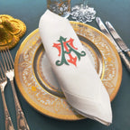 Embroidered linen dinner napkins with elegant monogrammed embroidery for fine dining table