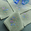 Embroidered linen dinner napkins with elegant monogrammed embroidery inspired by Versailles motive for fine dining table