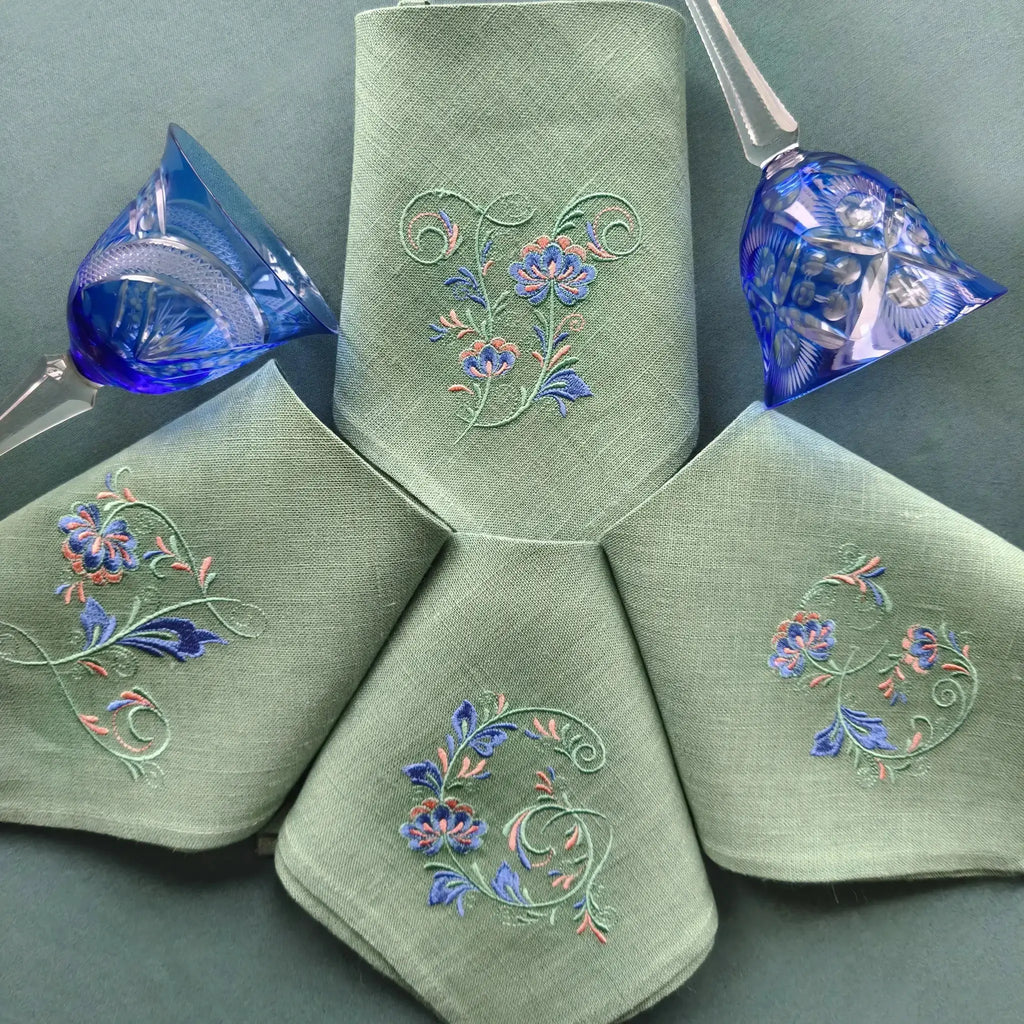 Embroidered linen dinner napkins with elegant monogrammed embroidery inspired by Versailles motive for fine dining table
